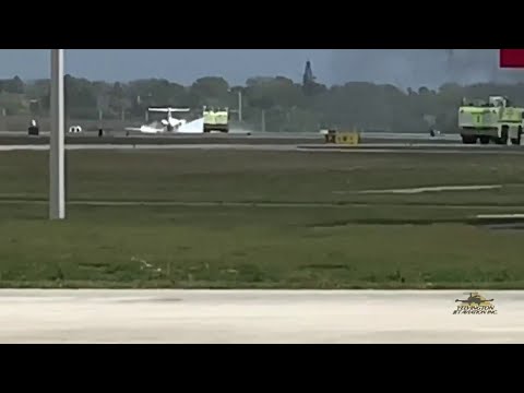Video shows plane skidding down runway with flames trailing behind at Daytona airport